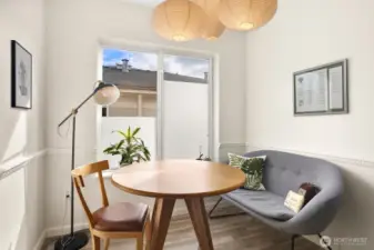 Dining area with large window and stylish lighting