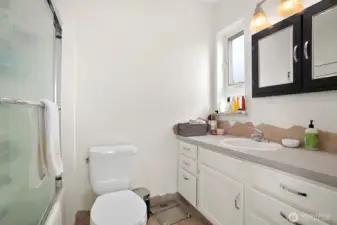 Main full bathroom with vanity, tub/shower combination