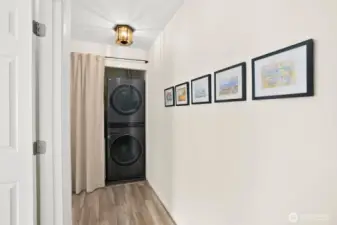 Laundry area with top of the line energy star full sized stacked washer and dryer