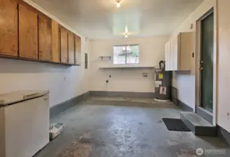 Single car garage for storage or parking with washer/dryer hookups on back wall.