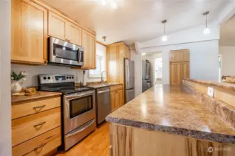 Nicely updated light and bright kitchen with SS appliances, solid wood cabinets ,pantry and plenty of counterspace.