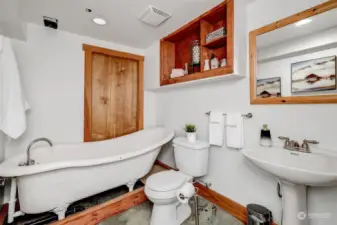 Lower level full bath with clawfoot tub. (hot water heater behind the door)