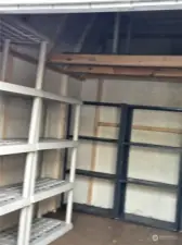 Storage unit has a lot of shelving and a loft for all your extras.