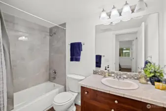 Updated contemporary guest bath with tub and full size shower.