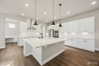 Kitchen Featuring Large Island and Under Cabinet Lighting