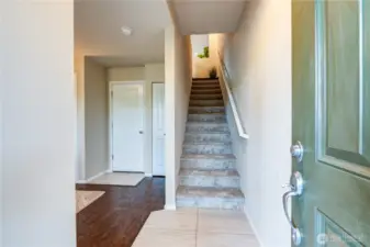 Ground floor entry with flex room/office to the left, half bathroom, garage entry & stairs to the main living space. Brand new carpet & interior paint.