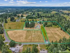 A private driveway with automatic gate leads you through scenic apple orchards to the heart of the estate.