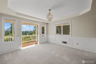 A light filled dining room off the kitchen with walk out to the deck and epic view.