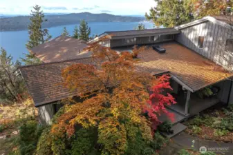 This shows the front entrance and garden area of the easts side of house. Views across East Sound Double Mountain and west side of Orcas in background, north westerly direction.