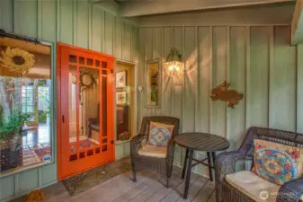 Front door and cozy sitting area located on the east side of the home.