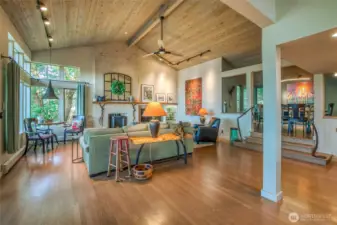 Propane fireplace warms this living space . Big windows looking to the water views to the west. This view is taken from the kitchen. Dining area to the right of this frame.