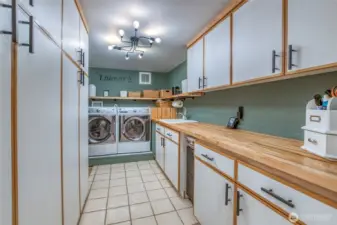 Large laundry room off the kitchen area offers plenty of storage and counter space.