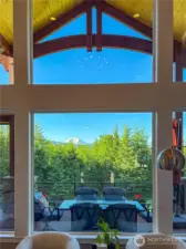Picture view window looks out to the entertainment space, the dramatic arched beams, Mount Rainier and territorial views.