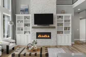 Stone floor to ceiling fireplace with builtins.
