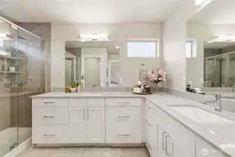 Elegant primary bathroom with dual vanity and modern fixtures