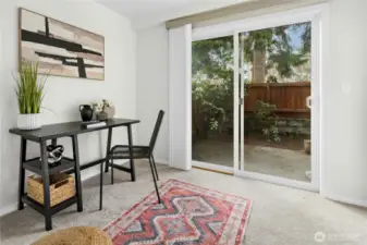 Versatile lower-level flex space with attached bathroom — ideal as a den, office, guest suite, or potential bedroom.