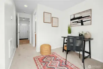 Versatile lower-level flex space with attached bathroom — ideal as a den, office, guest suite, or potential bedroom.