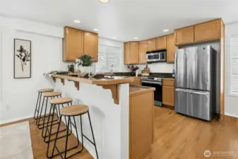 Kitchen features newer appliances, ample cabinetry, and seamless flow into the dining area for easy entertaining