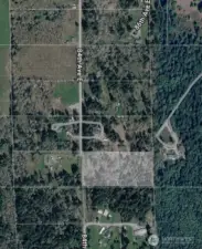 Parcel is faded out in picture to show in relationship to the neighborhood.