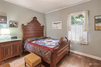 Spacious primary bedroom features hardwood floors and cedar lined closet.