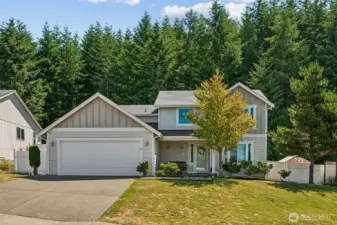 Front view of home, I love the vinyl fencing and huge trees behind this beautiful home.