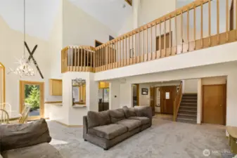 Walk into the open concept Living/ Kitchen/Dinning area with vaulted ceilings and open walkway to the upstairs.