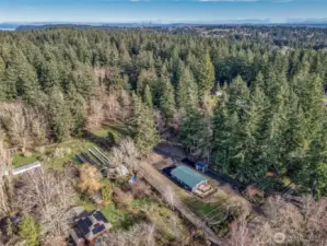 aerial view with property extending back beyond the clearing.