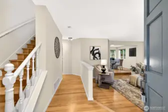 Step inside to a gracious foyer where refinished hardwood floors, fresh neutral paint, and an open sightline through to the main living areas immediately convey the sense of space, light, and easy flow this home delivers on every level.