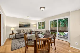 The informal dining and family room combination opens directly to the backyard patio through a sliding glass door, blending indoor and outdoor living in a bright, relaxed space that is perfect for everyday enjoyment.