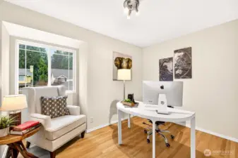 A final bedroom with hardwood floors and a bright window overlooking the neighborhood greenery adapts beautifully to an optional fifth bedroom or to a private home office — an increasingly valuable feature for Eastside professionals working from home near Microsoft, Google, and Meta campuses.