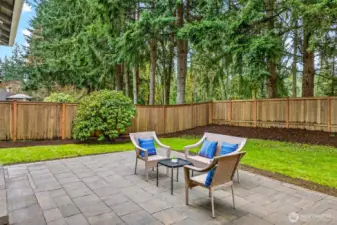 Framed by a wall of soaring firs and a fully fenced perimeter, the back patio delivers the kind of private outdoor retreat that is increasingly rare on the Eastside — a genuinely peaceful setting for morning coffee, evening conversation, or simply unwinding after the workday.