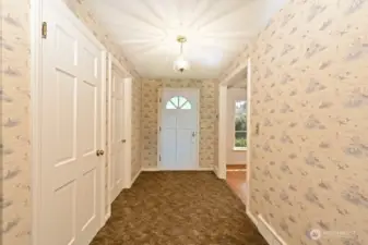From front hall to main entry.  It's carpeted but those hardwood floors lay underneath similar to the hardwoods in the living room to the right.