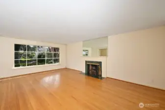 Looking east south east to the front in living room. Another huge window to light it all up.