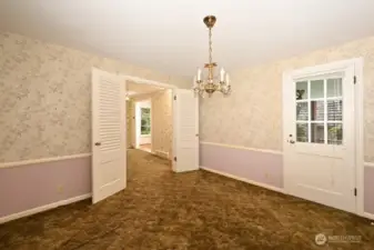 Dining Room looking east south east to the entry hallway and living room. Has it's own door to the back patio.