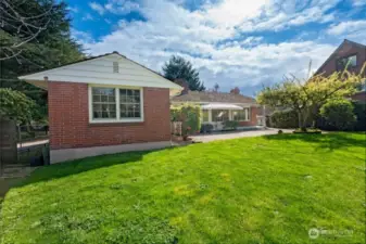 Backyard looking east to house. Primary bedroom (#3) on left. Large lawn and long patio to enjoy!
