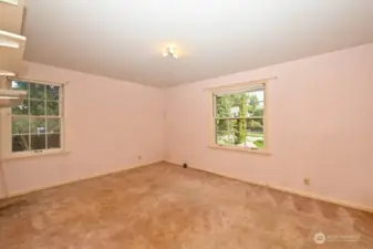Bedroom #2 in NE corner of house. Windows to the north side and front. Again, hardwood floors underneath.