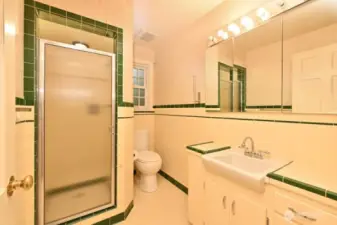 Three-quarter Ensuite Bath with Primary Bedroom. Classic tile, newer window.