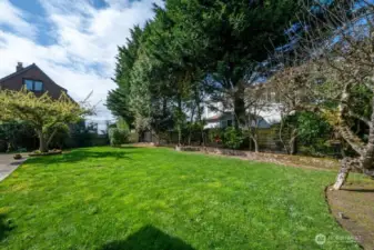 Large backyard looking south. Landscaping provides privacy for the large lawn yet offers space for your own creativity.