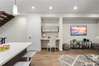 Photo of previous model Avenue plan (there is 1 more of this plan left in this phase). Large living room has ample space for a sectional, chairs, and entertainment center.  Work from home space (or bar setup) and pantry closet included.  You are welcome!