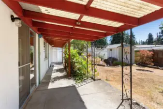 Coming out of kitchen onto patio with coverage.