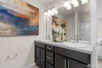 Primary ensuite bath features double vanity, modern fixtures, and a large shower/tub combo.