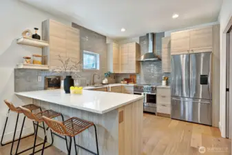 Beautiful kitchen w/ SS appliances, Quartz counters and stunning tile work.