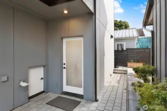 Back entrance just off mudroom w/ storage space, which leads to the private parking space for this home.