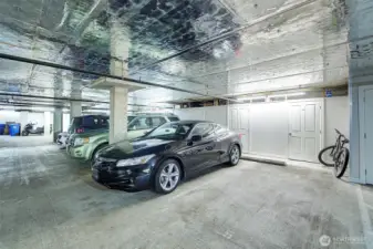 Garage parking right next to elevator with storage unit