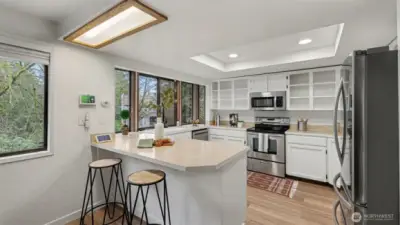 A bright and functional kitchen featuring a spacious peninsula with seating—perfect for casual dining or morning coffee.