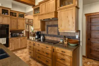 Cook's delight of rustic maple custom cabinets, induction glass cooktop, double ovens, double sink, & more. The original owner was a cabinet designer, & you'll see those touches throughout!