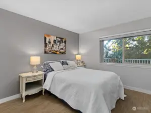 Large bedroom is flooded with natural light.