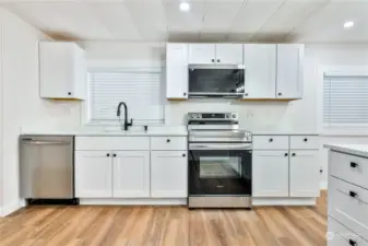 New cabinets, countertops and SS appliances modernizes this kitchen.