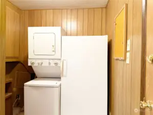 Utility Room off the Kitchen features a stack washer/dryer and an upright freezer -- all included in the sale of the home.