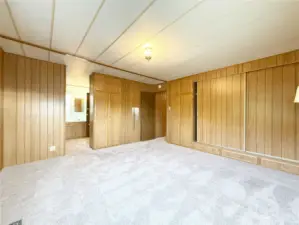 The Primary Suite also features a wall of closet space with built-in cabinets. Connected to the bedroom is the Primary Bathroom with a water closet.